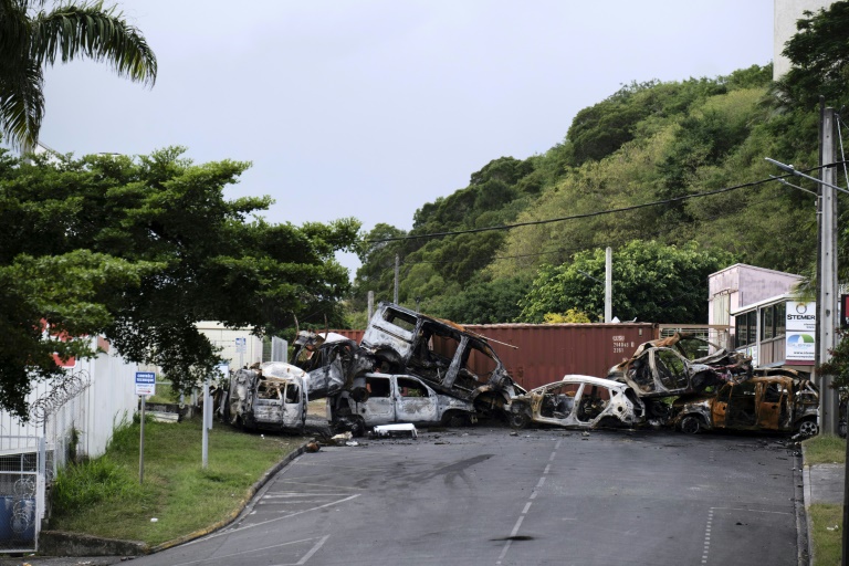 Un barrage de carcasses de voitures le 29 mai 2024 à l'entrée de la zone industrielle de Ducos, à Nouméa