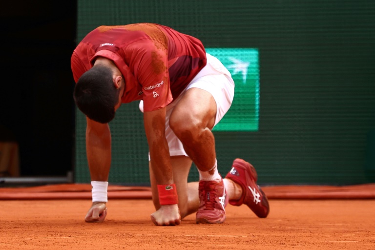 Novak Djokovic à terre après sa chute en 8e de finale de Roland-Garros contre Francisco Cerundolo. Blessé, mais poussé par le public, le Serbe remportera la rencontre, lundi 3 juin 2024.