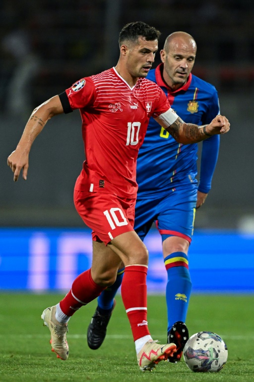 Le milieu de terrain suisse Granit Xhaka devant le défenseur andorran Ildefons Lima lors des qualifications pour l'Euro-2024 au stade Tourbillon le 12 septembre 2023 à Sion