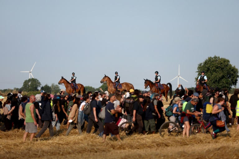 Des gendarmes à cheval empêchent les manifestants de se rendre dans les champs pour participer à un cortège en route vers Saint-Sauvant contre la construction de réservoirs d'eau géants (méga-bassines), à Saint-Martin-les-Melle, le 19 juillet 2024 dans les Deux-Sèvres