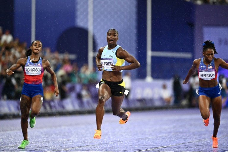 La sprinteuse de Sainte-Lucie Julien Alfred (au centre) en finale du 100m des JO-2024, avec l'Américaine Sha'Carri Richardson (à gauche), le 3 août au Stade de France