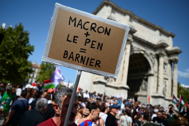 Une pancarte brandie par un participant à une manifestation contre la nomination comme Premier ministre de Michel Barnier par Emmanuel Macron, à Marseille le 7 septembre 2024