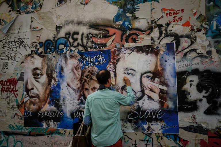 Un visiteur écrit un mot sur la façade de la Maison Gainsbourg, à Paris, le 20 septembre 2023