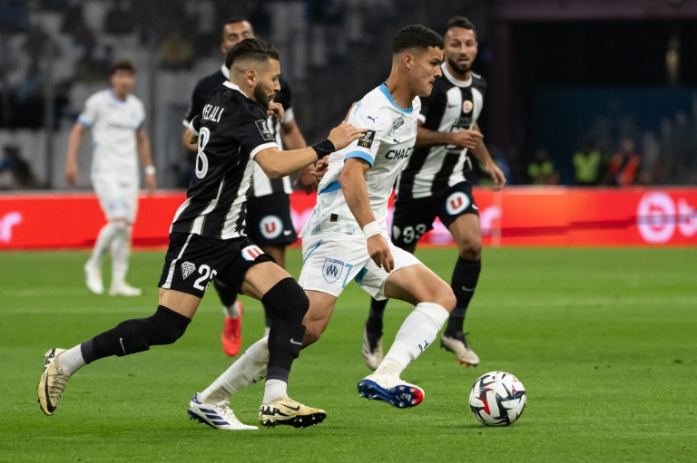 Le milieu argentin de l'OM Valentin Carboni (d) devance l'attaquant algérien d'Angers Farid El Melali (g), le 4 octobre 2024 au Stade Vélodrome