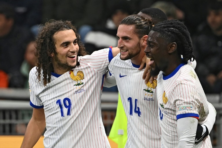 Les Français Matteo Guendouzi (g) et Manu Koné (d) félicitent Adrien Rabiot, buteur contre l'Italie en Ligue des nations, le 17 novembre 2024 à Milan