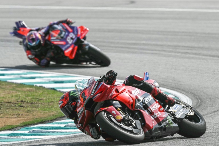 Les pilotes italien Pecco Bagnaia (devant) et espagnol Jorge Martin se livrent un mano a mano au Grand Prix de Malaisie à Sepang, le 3 novembre 2024