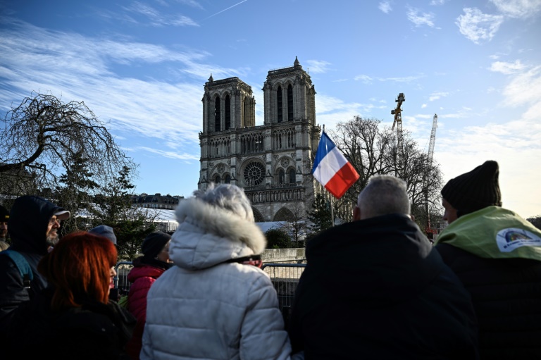 Des piétons admirent la cathédrale Notre-Dame de Paris à la veille de sa réouverture officielle, le 6 décembre 2024 à Paris