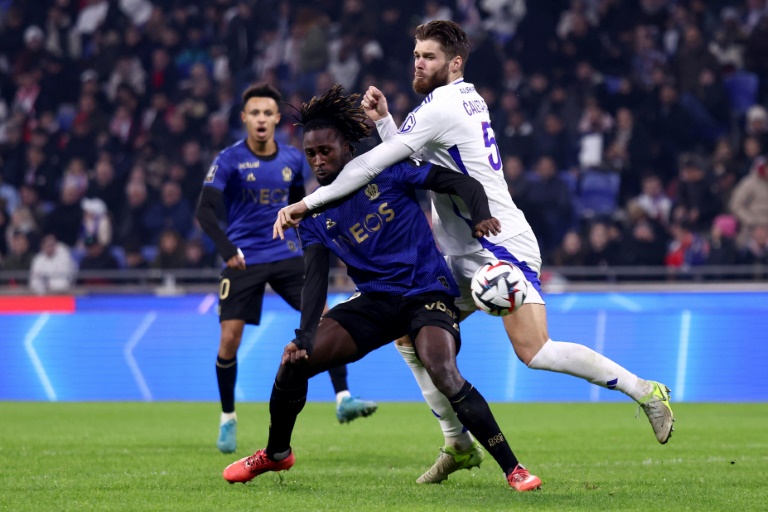 L'attaquant niçois Evann Guessand (C) au duel avec le défenseur lyonnais Duje Caleta-Car (D) pendant la rencontre de Ligue 1 entre les deux équipes, à Lyon, le 1er décembre 2024