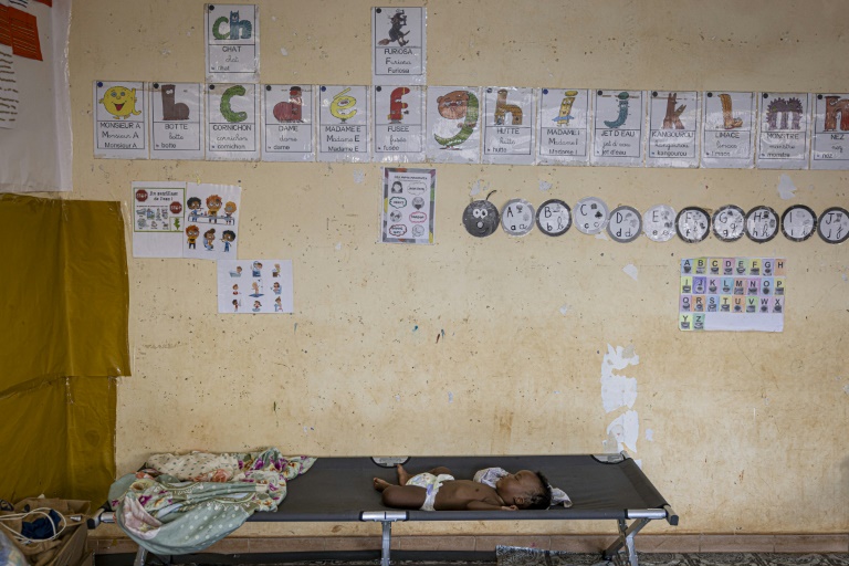 Un bébé dort dans une classe de l'école primaire de Longoni Bassin, dans la ville de Koungou à Mayotte, le 27 décembre 2024