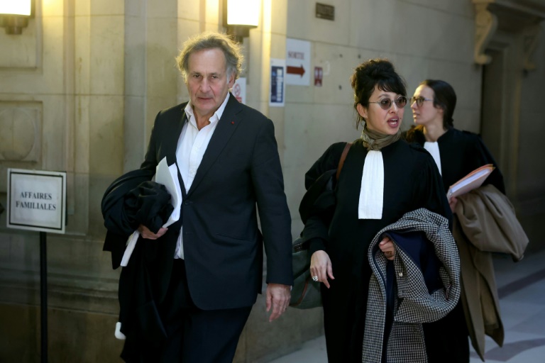 François Zimeray (g) et Jessica Finelle (c), les avocats de l'opposant cambodgien Sam Rainsy, arrivent à la Cour d'Assise de Paris, le 19 mars 2025